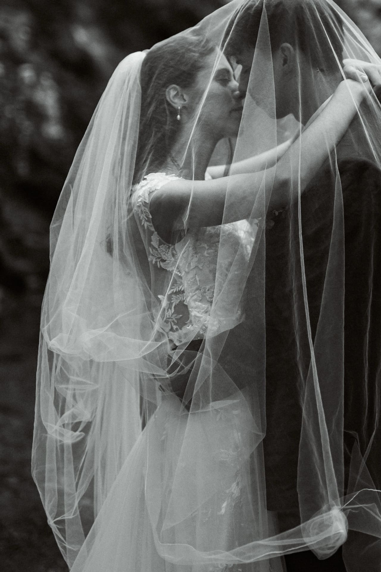 wedding planner in Savannah GA taking photos of bride in her wedding dress, kissing the groom